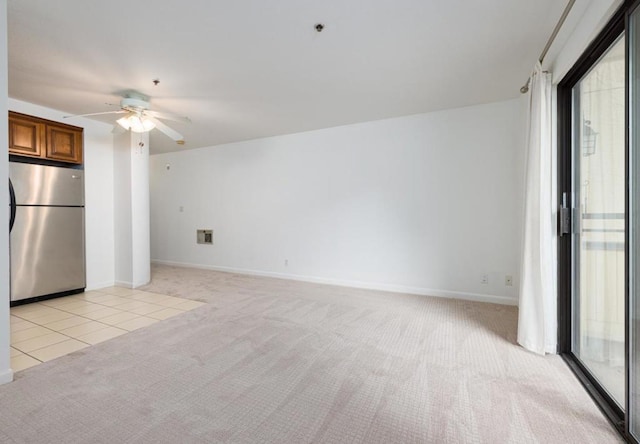 interior space with light carpet and ceiling fan