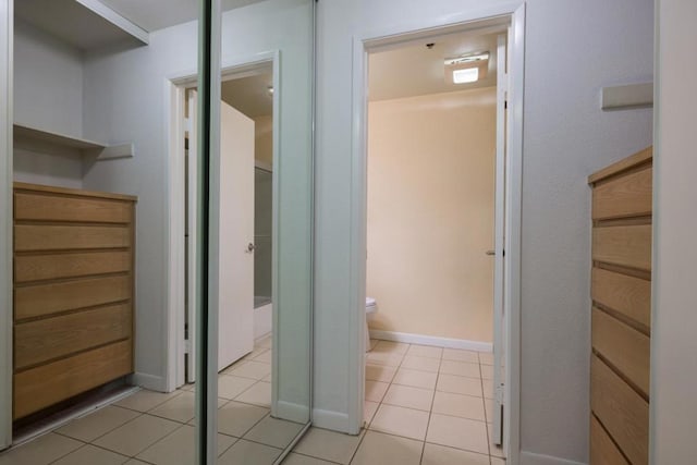 interior space featuring tile patterned floors and toilet