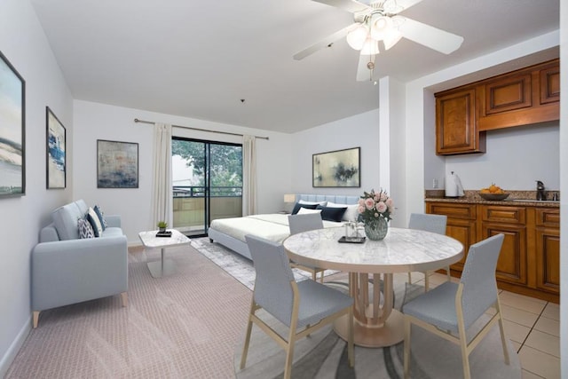 tiled dining room with sink and ceiling fan