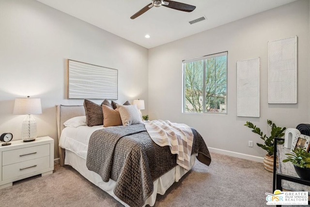 bedroom with ceiling fan and light colored carpet