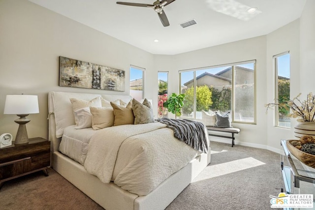 bedroom with ceiling fan, carpet flooring, and multiple windows