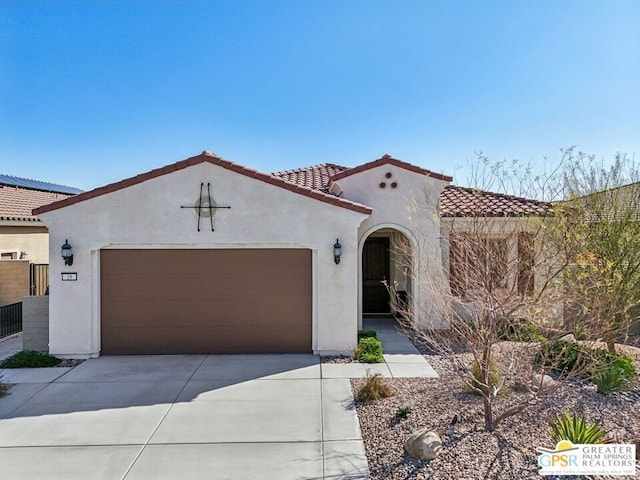 mediterranean / spanish-style house featuring a garage