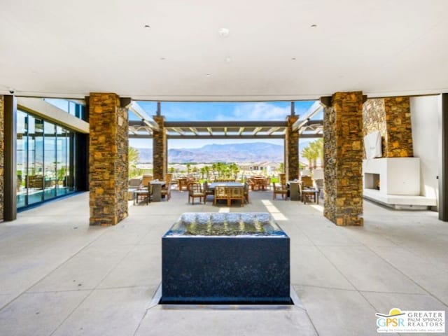 view of patio with a mountain view and a pergola