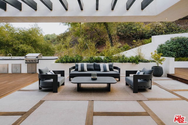 view of patio featuring an outdoor kitchen, sink, area for grilling, an outdoor hangout area, and a deck