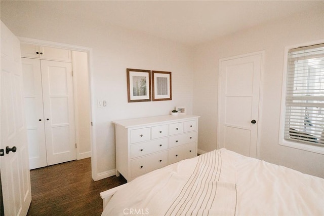 bedroom with dark hardwood / wood-style flooring