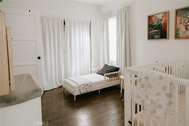 bedroom with dark wood-type flooring