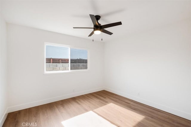 spare room featuring hardwood / wood-style flooring and ceiling fan