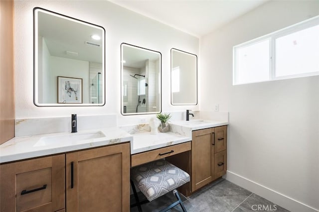 bathroom featuring tile patterned flooring, vanity, and a shower