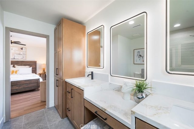 bathroom featuring ceiling fan, tile patterned floors, and vanity