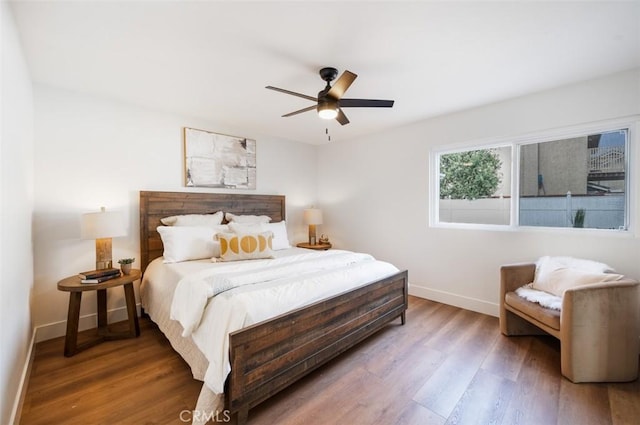 bedroom with hardwood / wood-style floors and ceiling fan