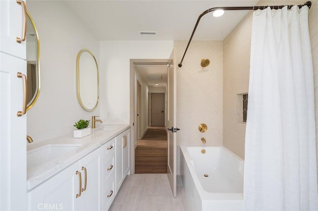 bathroom featuring shower / tub combo with curtain and vanity