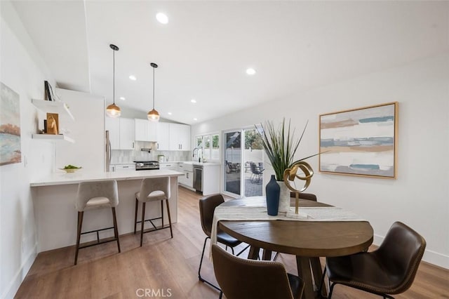 dining area featuring light hardwood / wood-style floors and sink