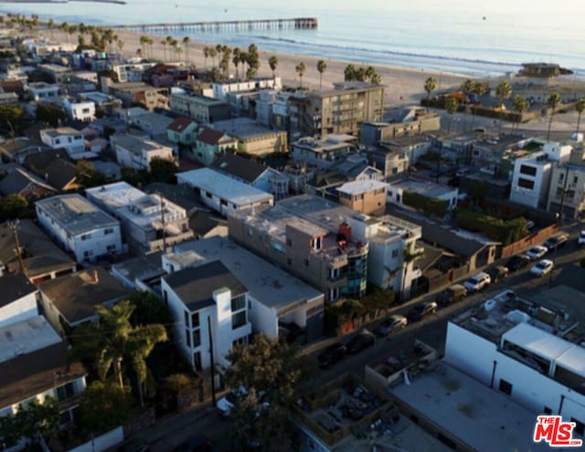 birds eye view of property with a water view and a view of the beach