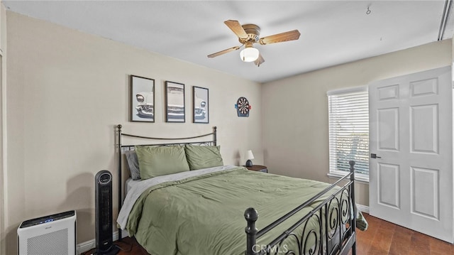 bedroom featuring ceiling fan and dark hardwood / wood-style floors