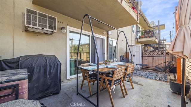 view of patio featuring an AC wall unit