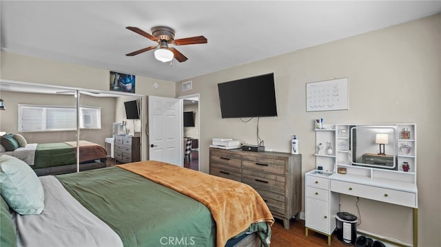 bedroom featuring ceiling fan, dark hardwood / wood-style flooring, and a closet