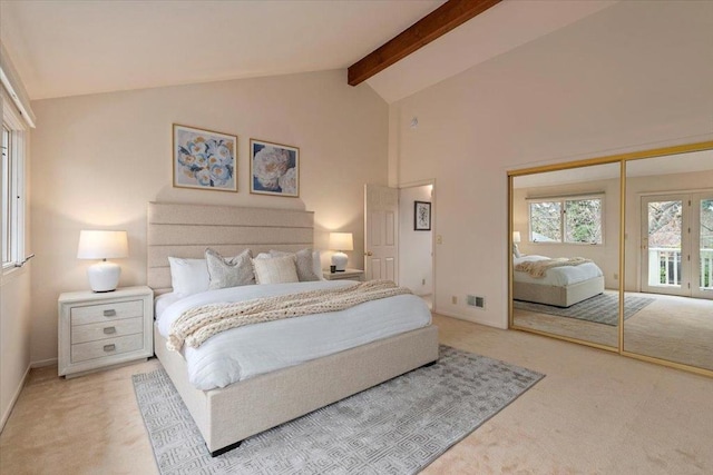 carpeted bedroom with beamed ceiling, high vaulted ceiling, and a closet