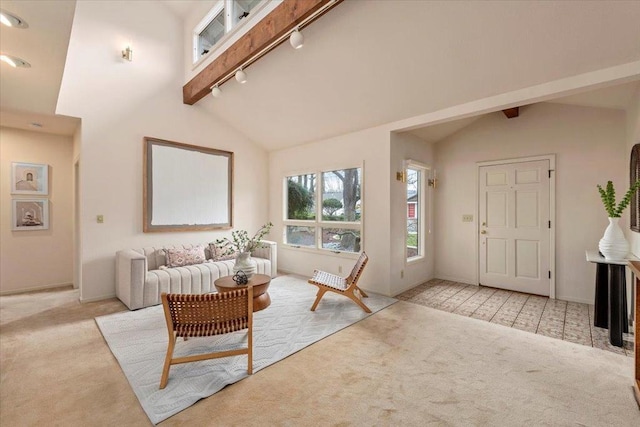 carpeted living room featuring high vaulted ceiling, track lighting, and beam ceiling