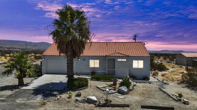 view of front of home with a garage and a mountain view