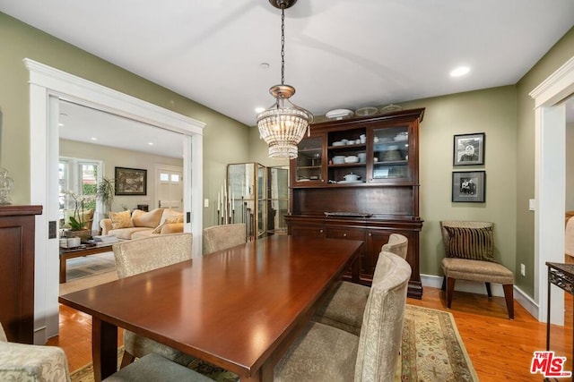 dining room featuring hardwood / wood-style flooring and a chandelier