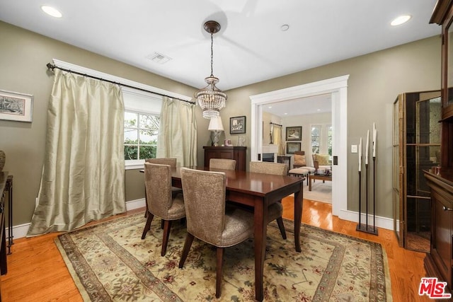 dining space with light hardwood / wood-style flooring