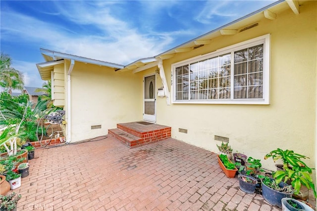 entrance to property with a patio