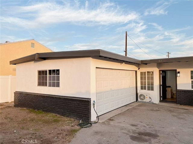 view of home's exterior with a garage and ac unit