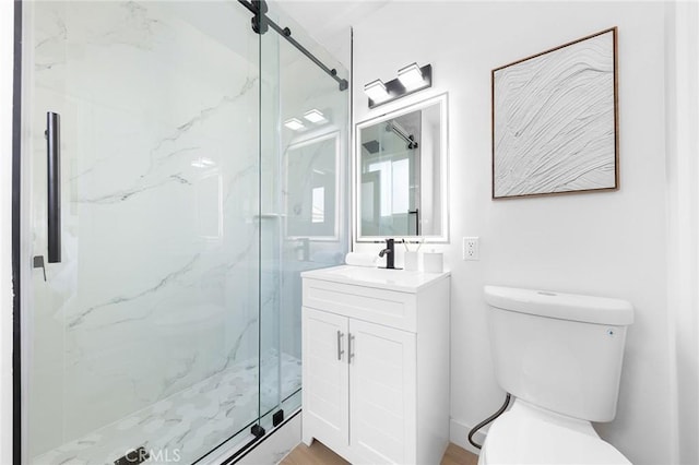 bathroom with vanity, toilet, and walk in shower