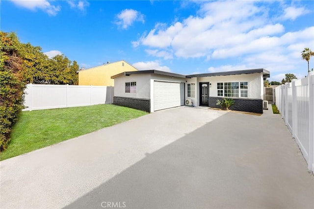 view of front of house with a garage and a front lawn