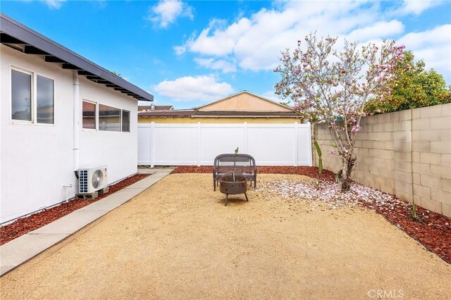 view of patio / terrace featuring a fire pit and ac unit