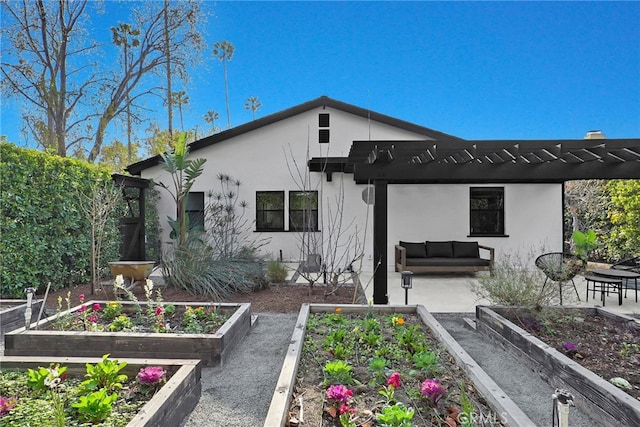 rear view of house with a patio, an outdoor hangout area, and a pergola