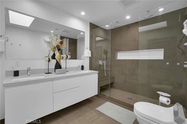 bathroom with vanity, an enclosed shower, and toilet