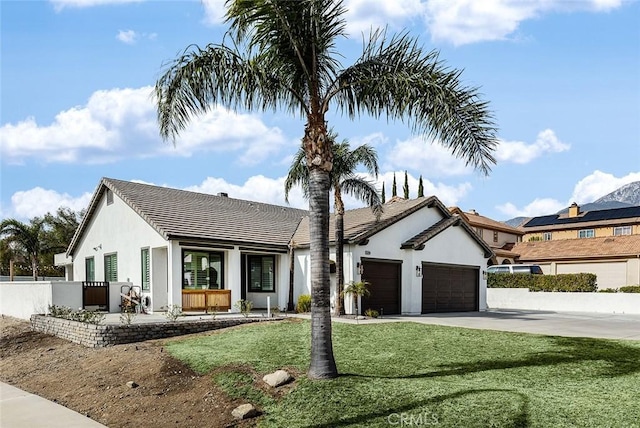 view of front of house featuring a garage and a front lawn