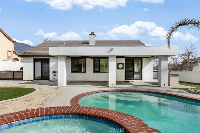 back of house with an outdoor kitchen, ceiling fan, and a patio area