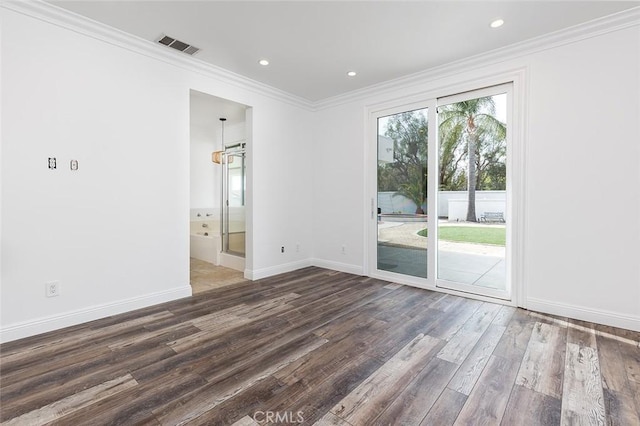 empty room with dark hardwood / wood-style flooring and crown molding