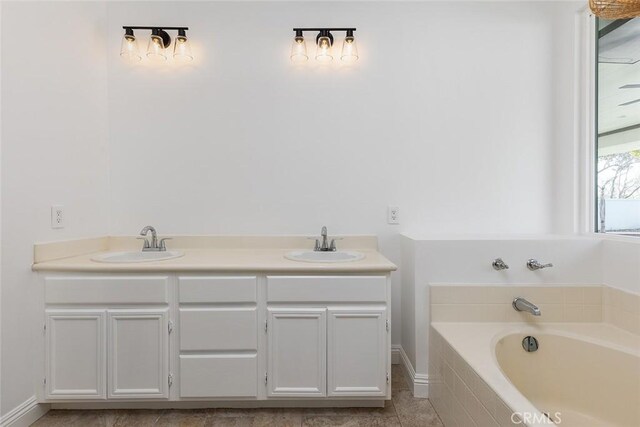 bathroom featuring vanity and a relaxing tiled tub