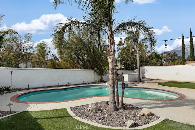 view of swimming pool featuring a mountain view and a patio