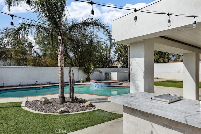 view of swimming pool featuring an in ground hot tub and a patio area