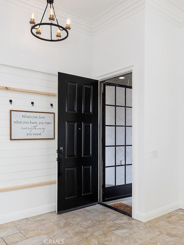 foyer featuring ornamental molding and a notable chandelier