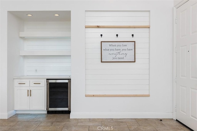 bar featuring white cabinetry and beverage cooler