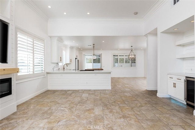 kitchen featuring white cabinetry, kitchen peninsula, and pendant lighting