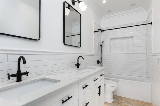 full bathroom with toilet, crown molding, tile walls, vanity, and tiled shower / bath combo