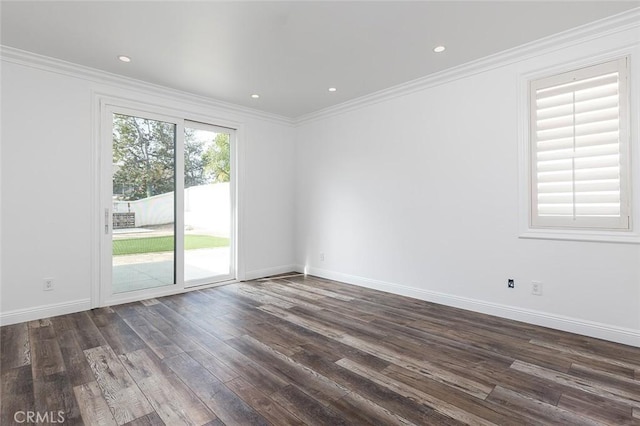 spare room featuring dark hardwood / wood-style flooring and ornamental molding