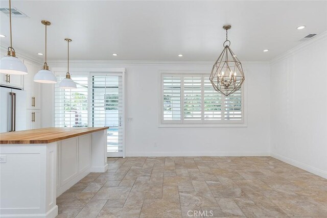 kitchen featuring a wealth of natural light, butcher block counters, and pendant lighting