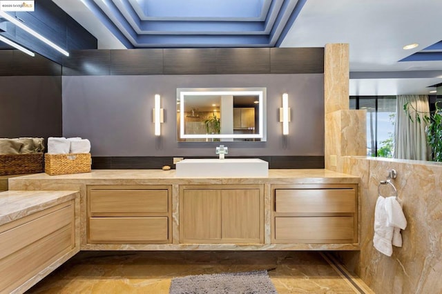 bathroom with vanity and a skylight