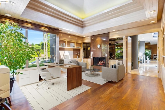 home office featuring wood-type flooring and a high end fireplace