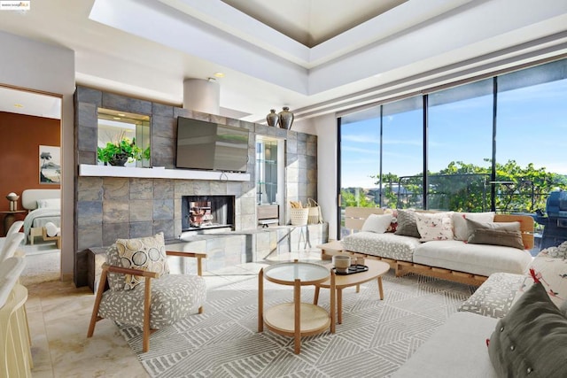 living room featuring a tiled fireplace