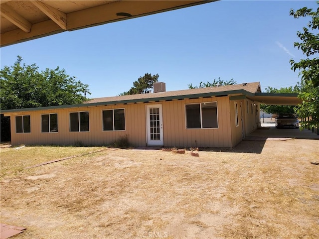 rear view of house featuring a carport