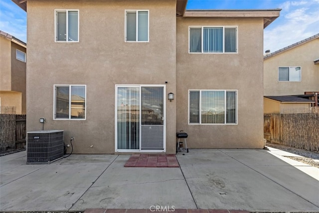 back of property featuring cooling unit and a patio