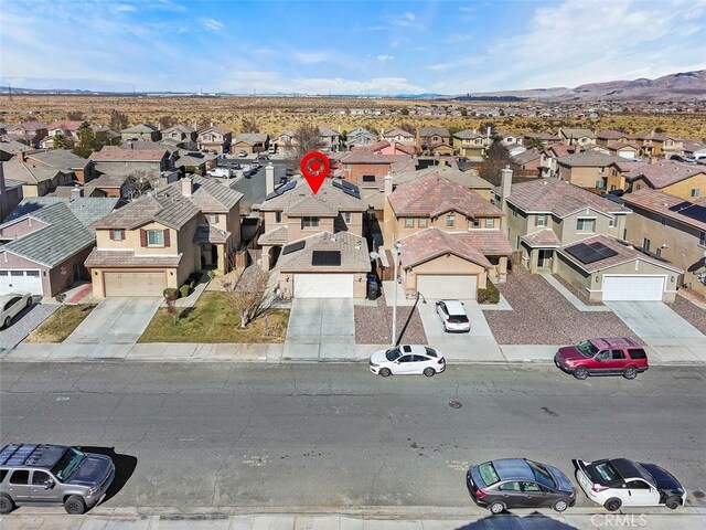 birds eye view of property featuring a mountain view